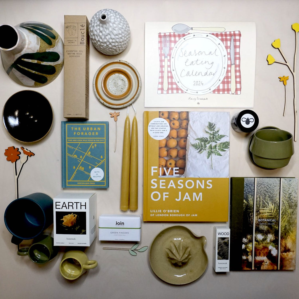 a selection of handmade homwares and products from UK makers all lying flat on a table with the image taken from above. all the products relate to gardening in some way. 