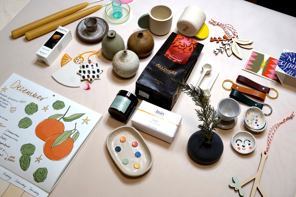 a selection of different handmade homewares and stocking fillers on a table. 