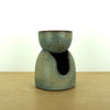 handmade oil burner by Aku Ceramics in Loch glaze sitting on a birch ply table with a white background.