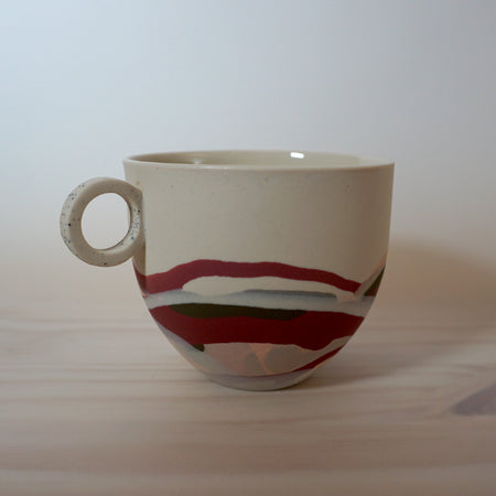 close up image of a marbled mug handmade in porcelain by anna jones ceramics. 