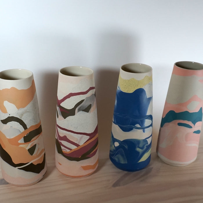 line of four marbled vases each in a different colourway by Anna Jones Ceramics. 