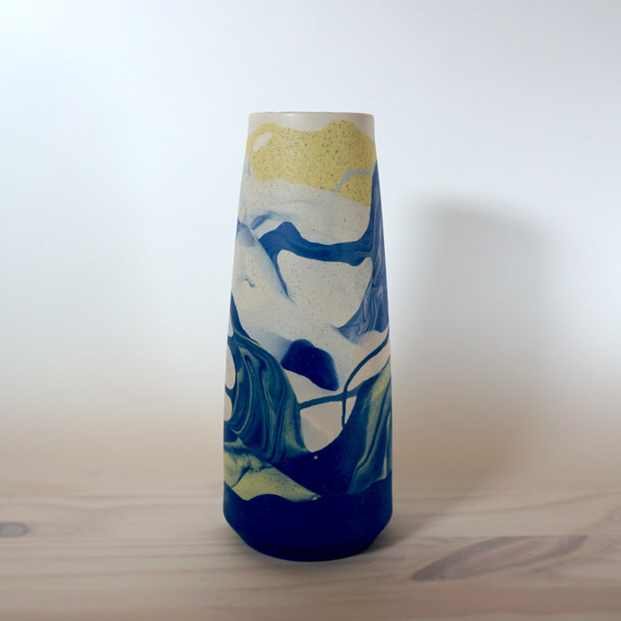 a blue and yellow marbled porcelain vase by Anna Jones Ceramics. 