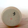 bottom of a handmade porcelain slipcast vase with the makers mark of Anna Jones Ceramics. 