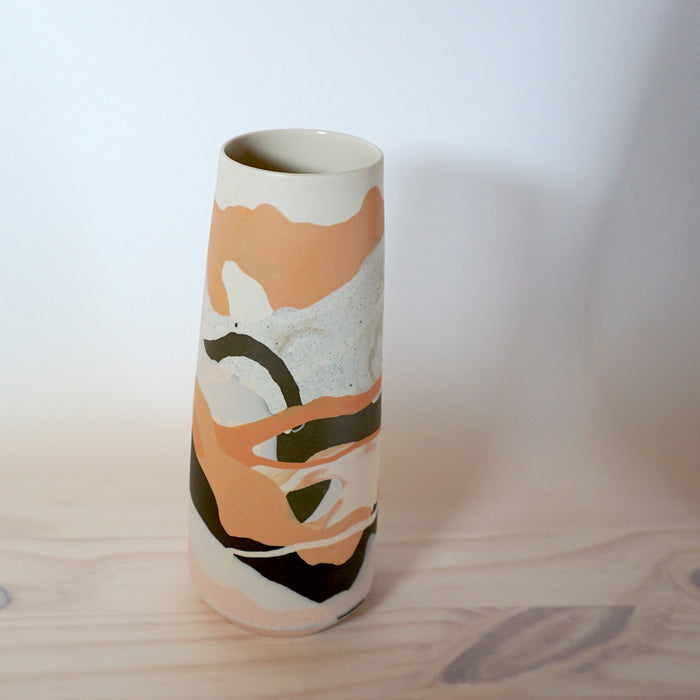 slipcast porcelain vase in shades of orange and brown. 