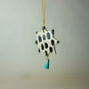 handmade ceramic Christmas decoration by Beci Callow with black spots and colourful tassel. 