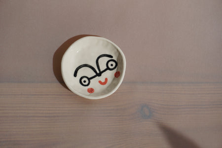 ceramic ring dish with a hand painted face by Beci Callow. 