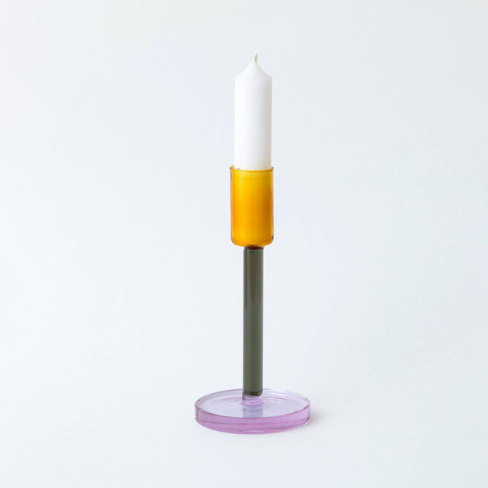 Coloured glass candlestick holder on white background