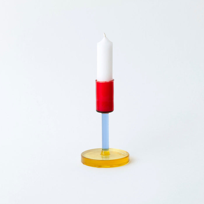 coloured glass candlestick holder on white background. 