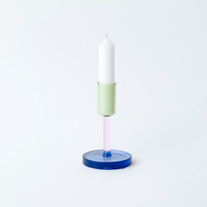 Coloured glass candlestick holder on white background