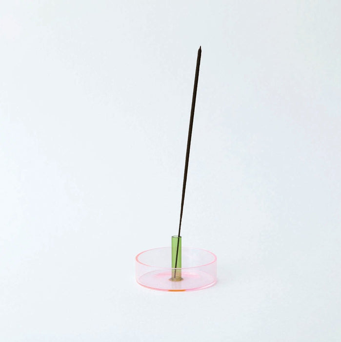 Coloured glass incense holder on a white background. 