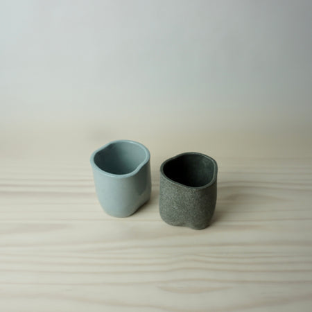 two irregular handmade tumblers by brutes ceramics. 