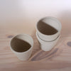 taken from above the detail of three white handmade coffee cups. 