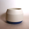 white planter with a deep blue base by maker Duck Ceramics. 