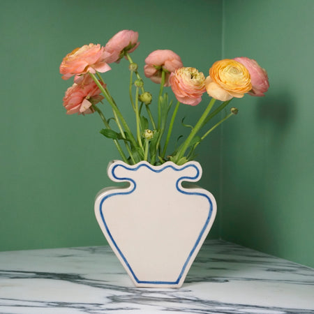 cream vase with blue outline pattern and pinky yellow flowers