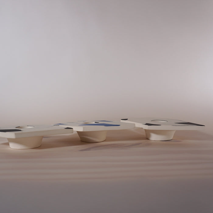 side view of three low candlestick holders, handmade out of porcelain from Kentish Town Stores. 