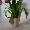 back view of a hand-built vase by Emily Marston Ceramics showing the stems of tulips. 