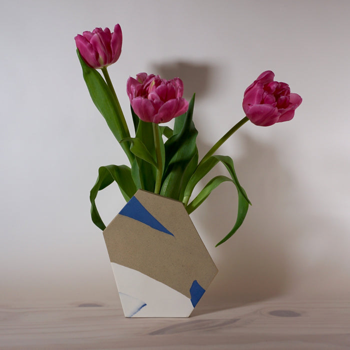 bunch of tulips in a handmade slab built porcelain vase by Emily Marston. 