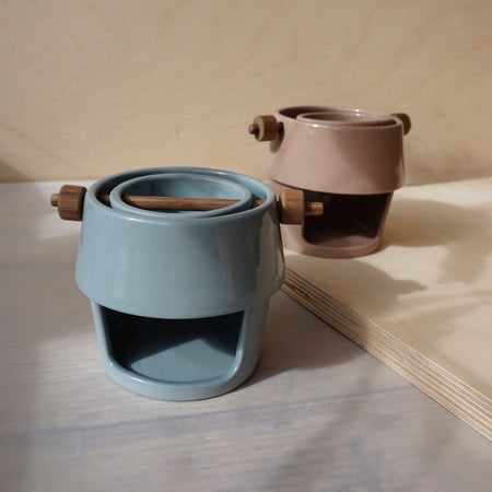 two ceramic oil burners with walnut dowels. 