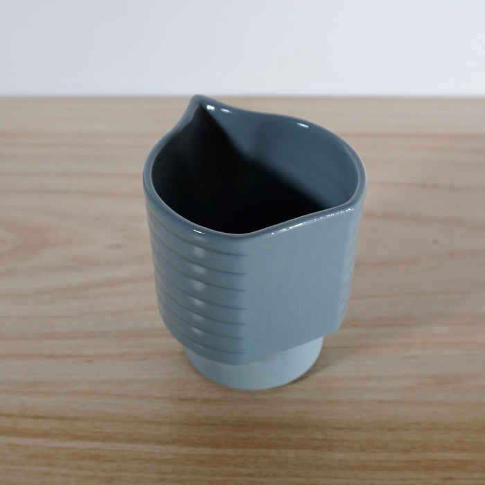 the back of a handmade jug in blue with lots of sharp clean angles and lines. 