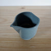 top view of a blue handmade slipcast porcelain jug with no handle. 