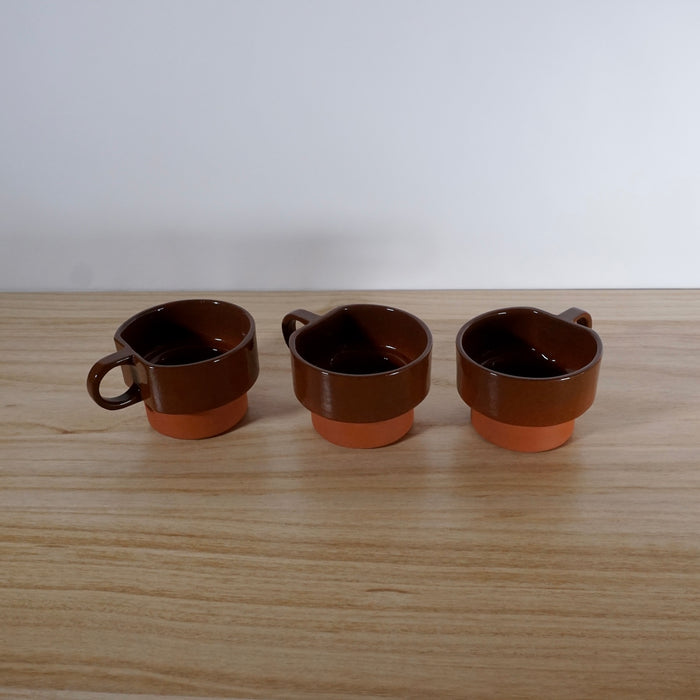 line of three handmade slipcast terracotta cups. 