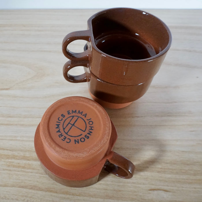 the makers mark of Emma Johnson Ceramics on the base of a small terracotta cup. 