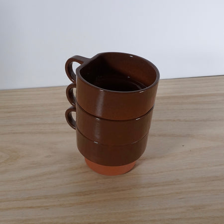 stack of three handmade terracotta cups. 