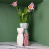 a group of three vases in red, white and green. with pink tulips