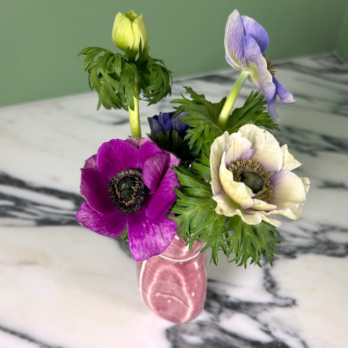 a bunch of flowers in a red vase. 