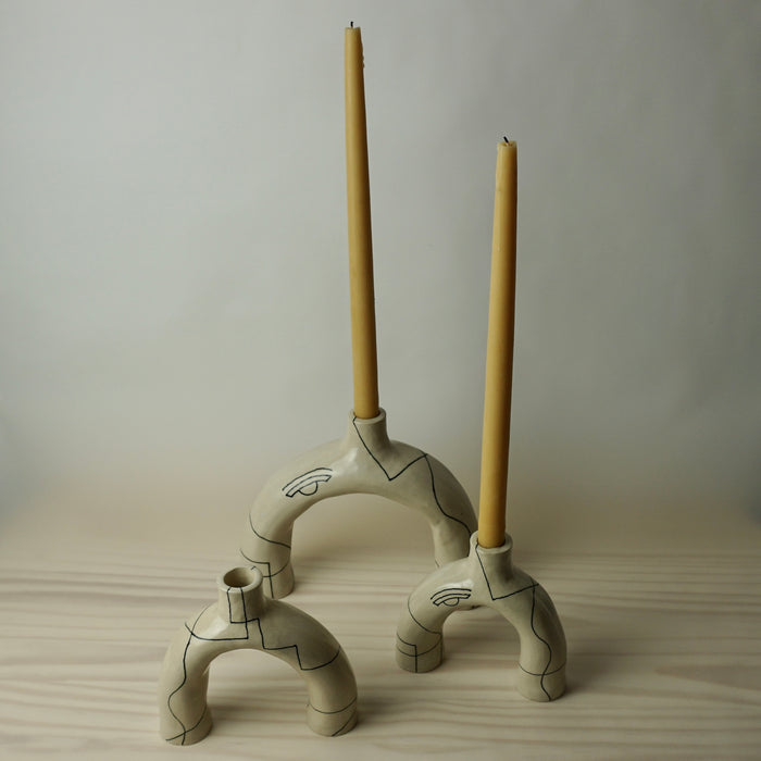 three sculptural candlestick holder in a cream stoneware with line drawing by HoodMor Studio. 