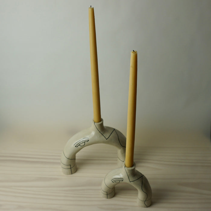 two sculptural candlestick holder in a cream stoneware with line drawing by HoodMor Studio. 