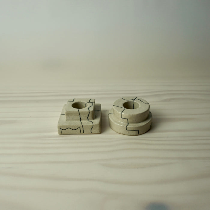 two simple tiered candlestick holder in a cream stoneware with line drawing by HoodMor Studio. 