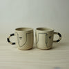 two really large handmade ceramic mugs with line drawing of faces by HoodMor