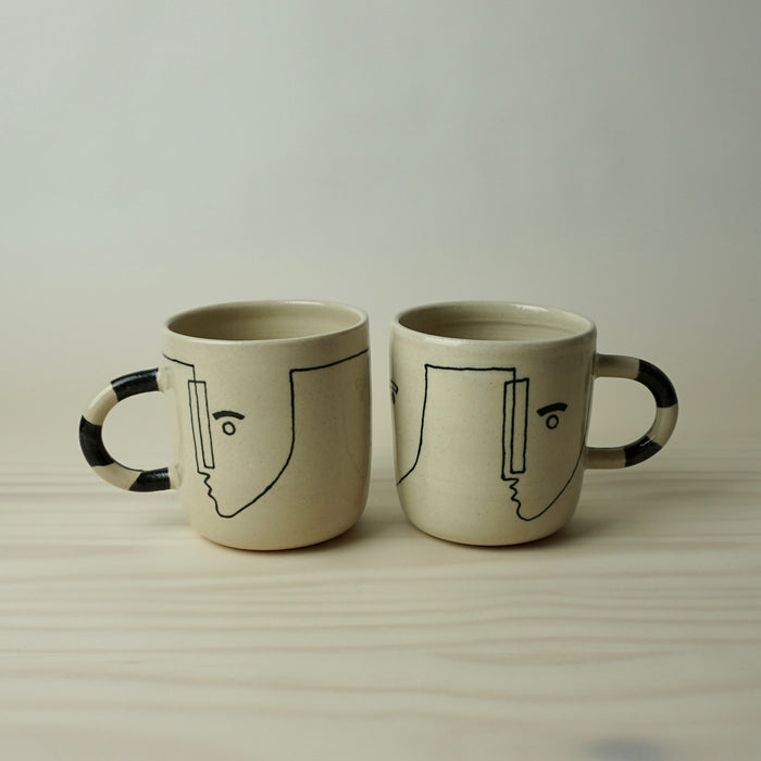 two really large handmade ceramic mugs with line drawing of faces by HoodMor