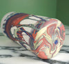 a handmade marbled vase lying on a table to show the base and the maker mark of JDP ceramics. 