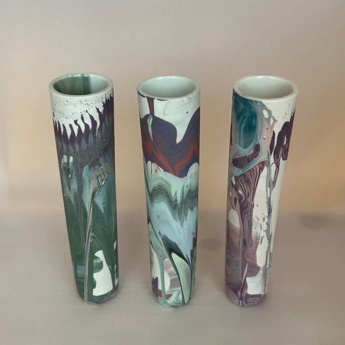 three actioncast porcelain bud vases. all with an individual marble pattern in shades of purple and green by JDP Ceramics. 