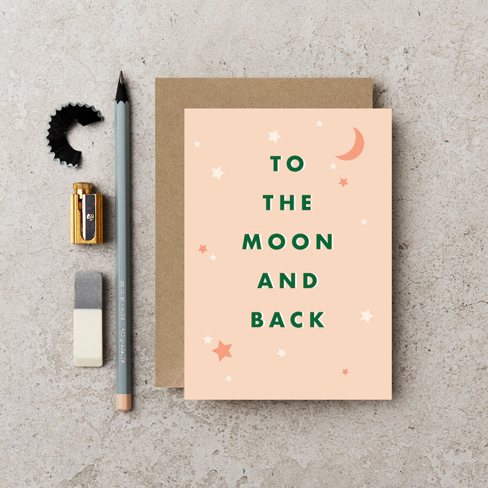 pink card with stars and moons that reads to the moon and back. 