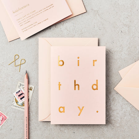 pink birthday card with gold foil letters. 