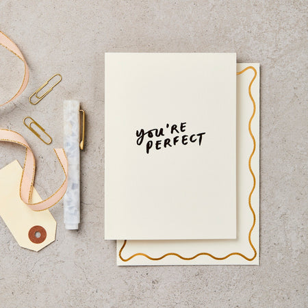 a black and white card that reads "you're perfect" 