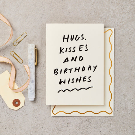 card that says "Hugs, kisses & birthday wishes" in italics. 