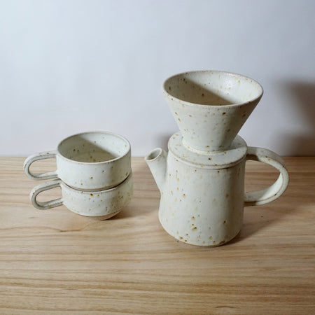 Mae Ceramics V60 with a coffee pot and two ridge cups all in Chalk. 