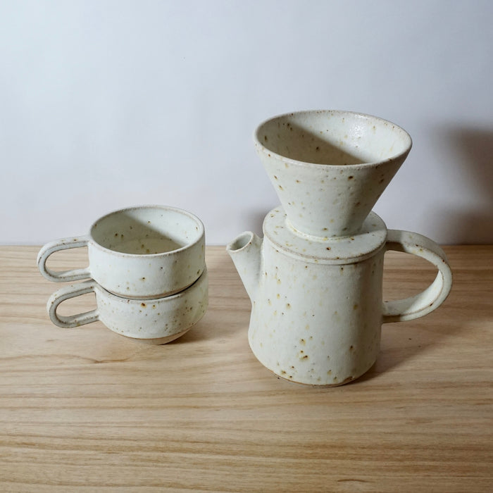 Mae Ceramics V60 with a coffee pot and two ridge cups all in Chalk. 