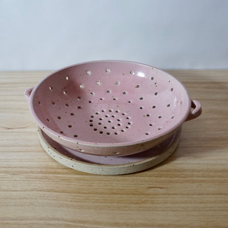 Mae Ceramics handmade colander and plate in stoneware and Pink glaze. 