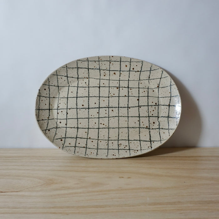 handmade oval platter with grid pattern by Mae Ceramics. 