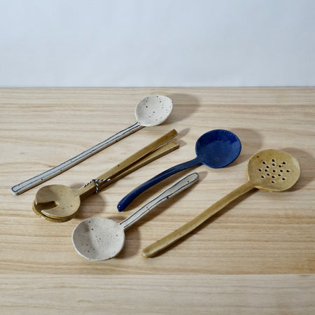 selection of handmade spoons by Mae Ceramics on a table 