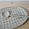 Mae Ceramics Grid Platter and Spoon on table. 