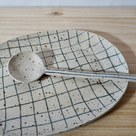 Mae Ceramics Grid Platter and Spoon on table. 
