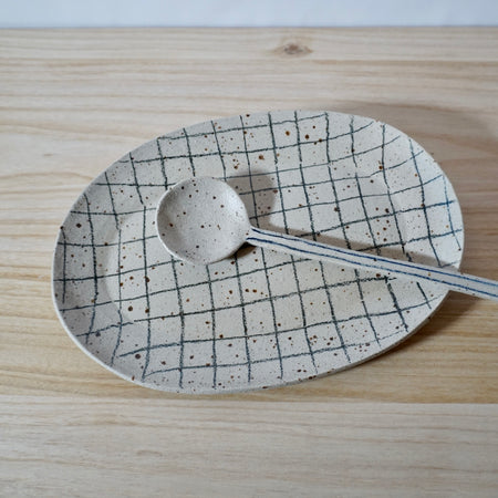 handmade oval platter with grid pattern and spoon by Mae Ceramics. 