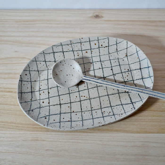 handmade oval platter with grid pattern and spoon by Mae Ceramics. 