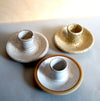 three handmade ceramic candlestick holders in three different glazes. 